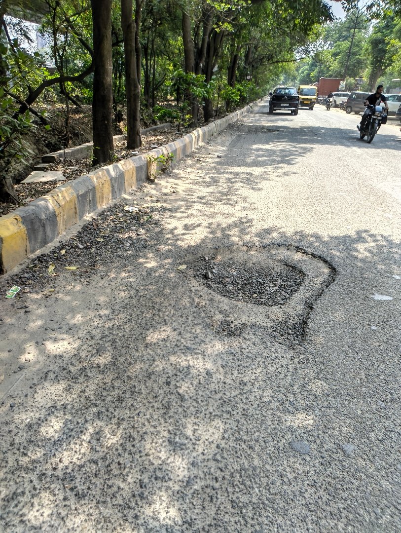 Broken road and back to back big potholesbsector 5 Vasundhara Hindon common road